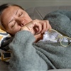 Woman resting on sofa with fatigue and perimenopause symptoms