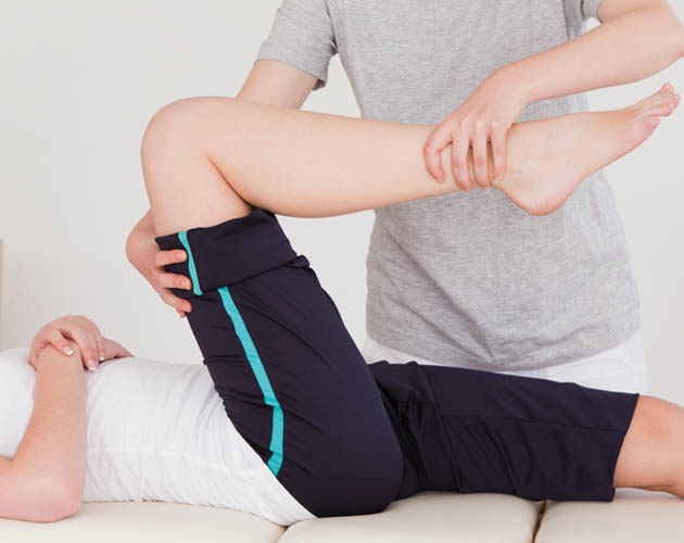 Trainer working with Member on muscle activation technique