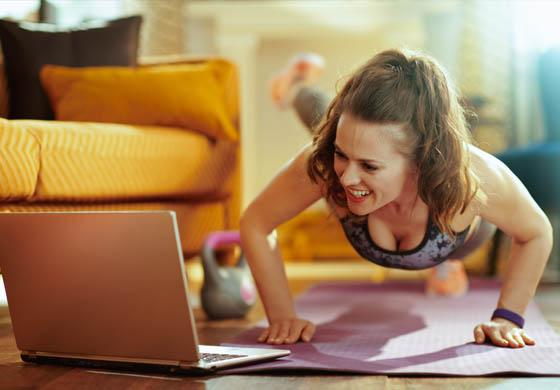 Woman doing a workout watching her laptop