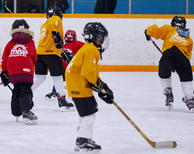 Kids playing hockey in MLSE Foundation jerseys