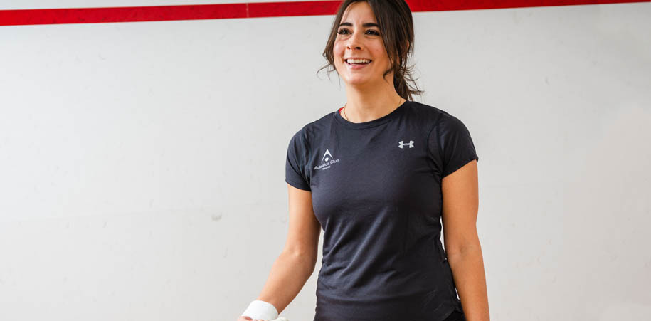 Female Member on the squash court, wearing an Adelaide Club branded t-shirt