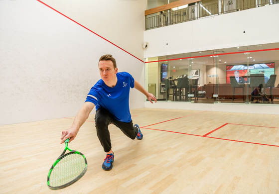 Man playing squash on our courts