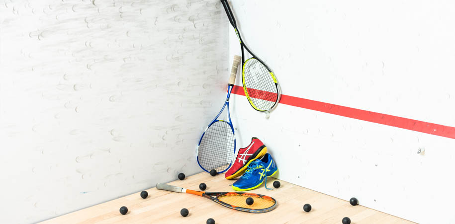 Squash racquets and shoes on a squash court