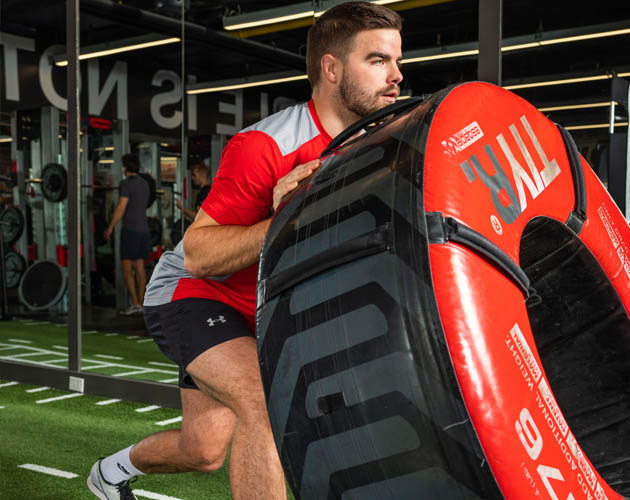 Member working with the tire in the Strength Gym