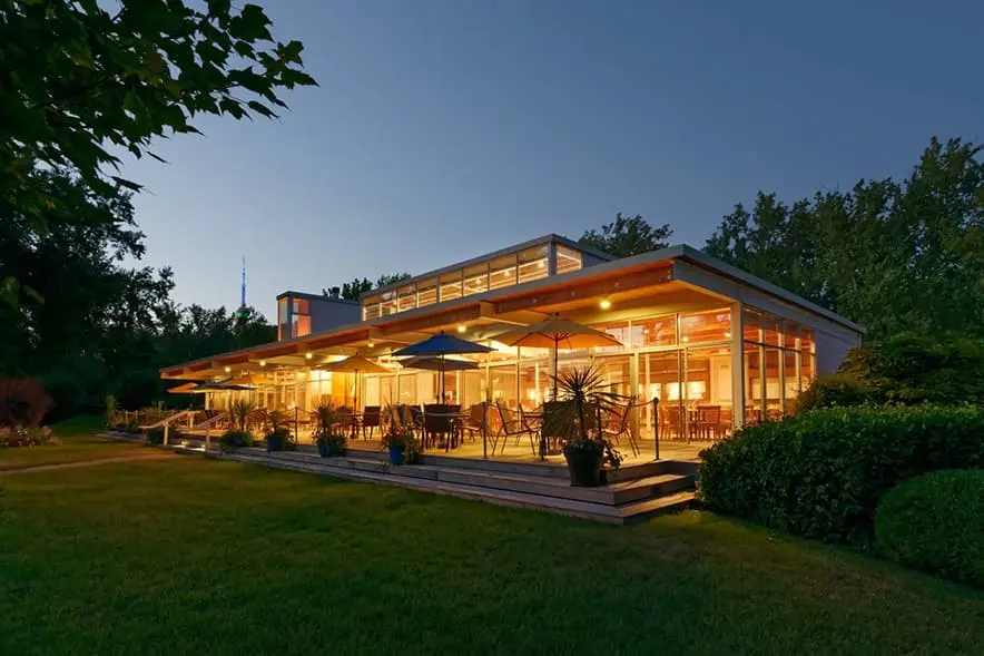 Clubhouse and terrace lit at dusk at the Island Yacht Club, a reciprocal club for Adelaide Club members