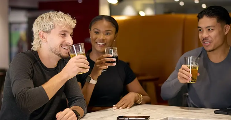 Three Adelaide Club members enjoying drinks together in the HUB lounge.