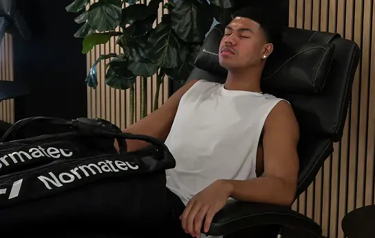 Member relaxing in a Normatec compression chair in the Adelaide Club Recovery Retreat.