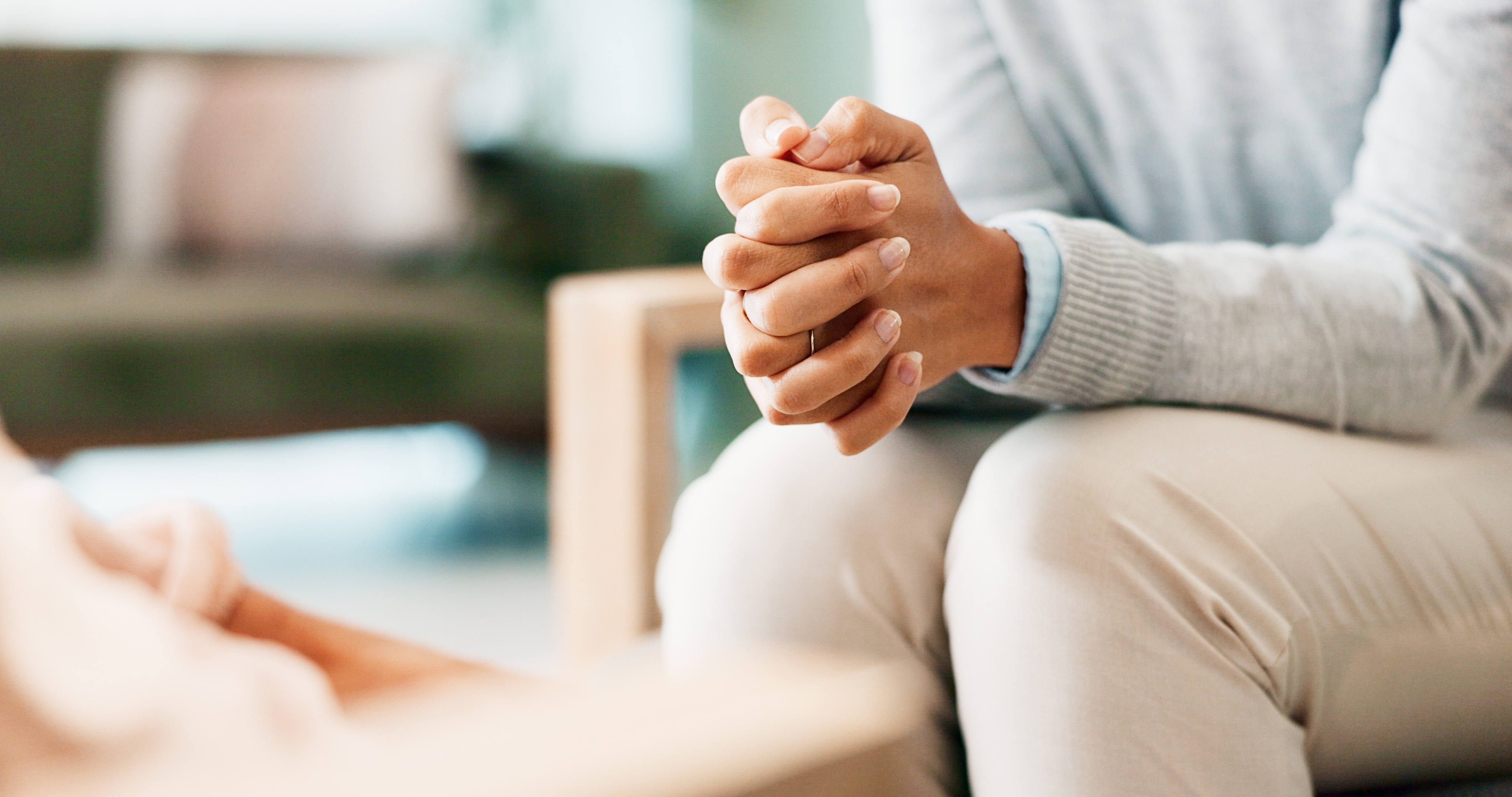 Patient discussing shoulder pain symptoms with a healthcare professional during an assessment for frozen shoulder and menopause-related musculoskeletal changes.