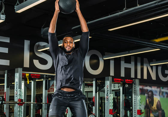 Fit male member doing a medicine ball slam in the Strength Gym at the Adelaide Club