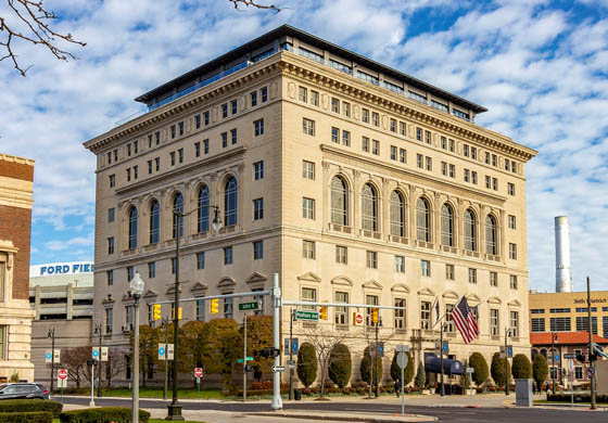 Detroit Athletic Club with bright blue, cloudy sky