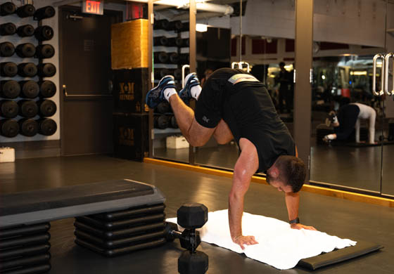 Fit man jumping over a step in a group fitness class in the Adelaide Club's Power Studio