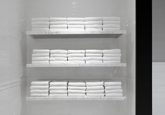 Stacked white towels in the wet area in the women's locker room at the Adelaide Club