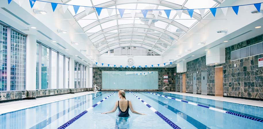 Woman swimming in the pool at the Terminal City Club in Vancouver, British Columbia